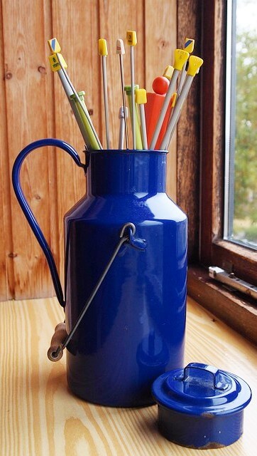 Straight knitting needles in a blue pitcher