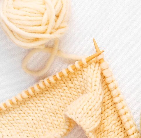 Knit Stockinette stitch in light yellow yarn with bamboo knitting needles